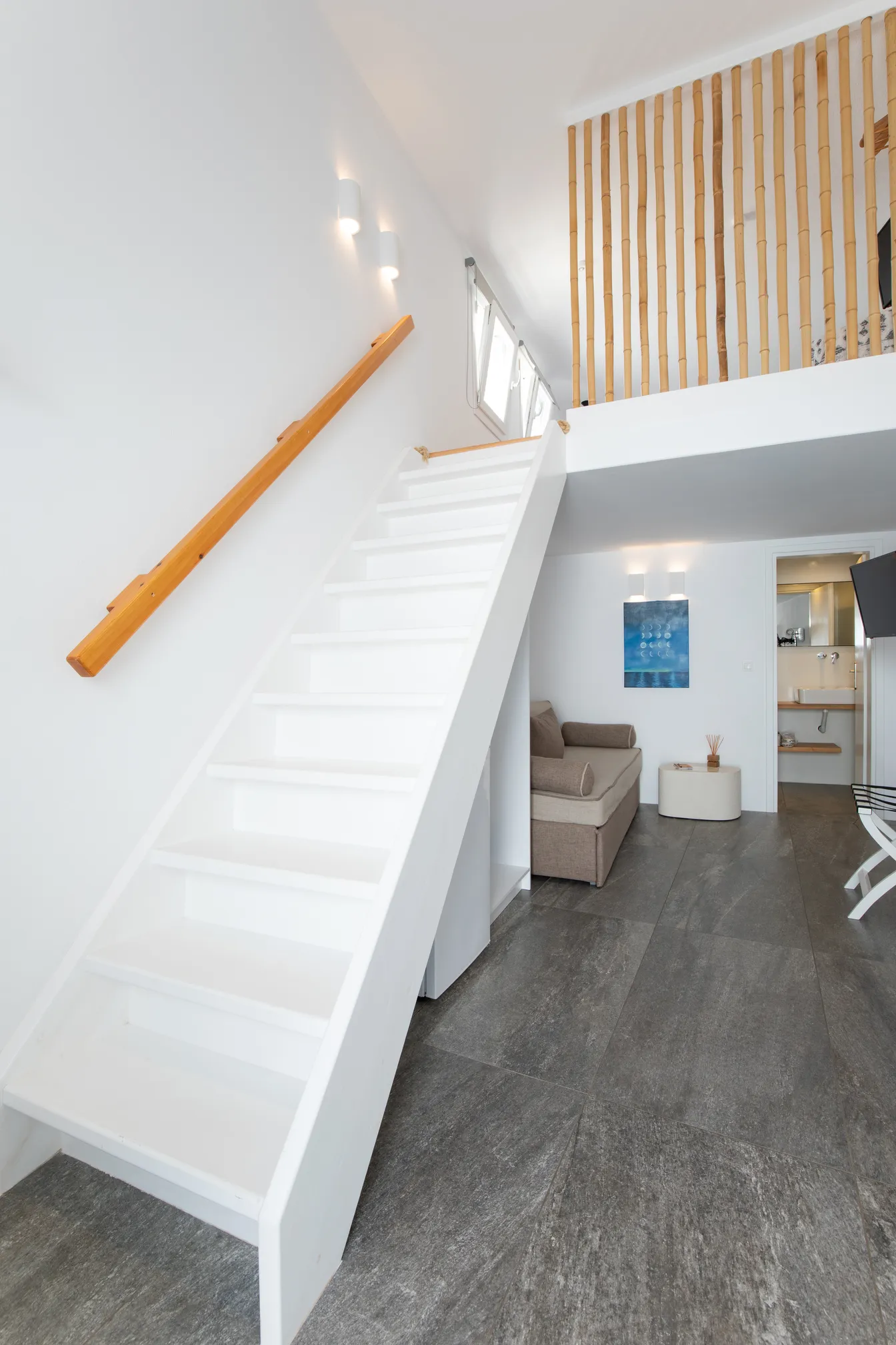 Staircase with wooden handrail to the loft